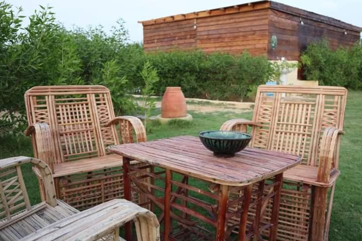 a wooden table with two chairs and a bowl on it at منتجع تونس فاير- Tunis Fire Resort in Tunis