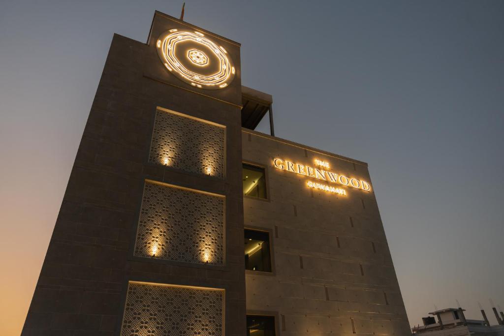 a building with a clock on top of it at The Greenwood Guwahati - A Luxury Boutique Hotel in Guwahati