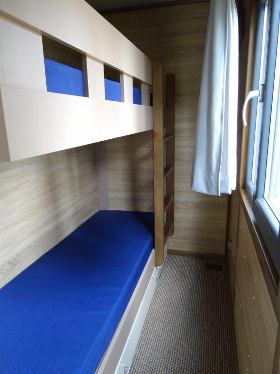 a bunk bed in a small room with a window at Sopot 34 przy plaży in Sopot