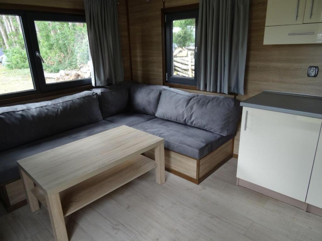 a living room with a couch and a coffee table at Sopot 34 przy plaży in Sopot