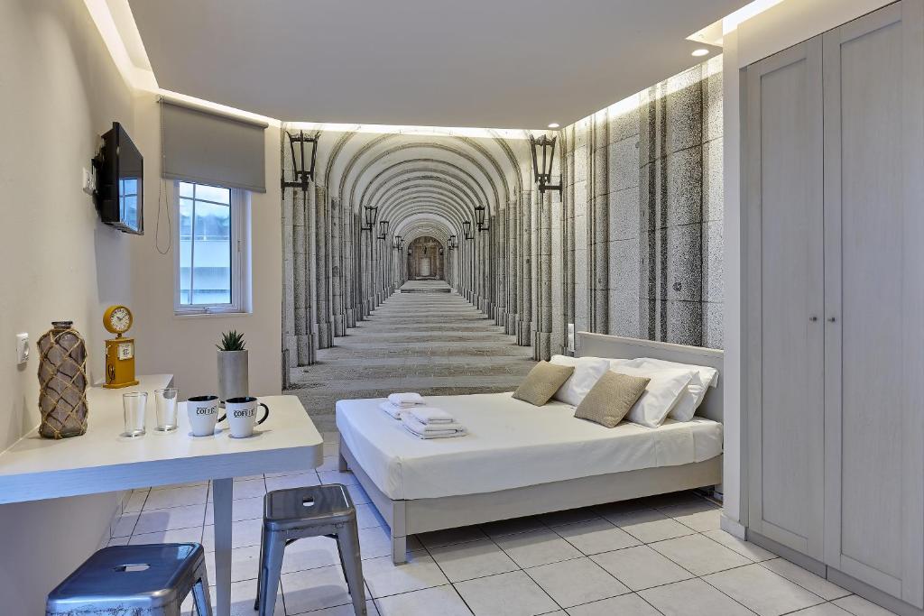 a room with a white bed and a hallway at Prime Room in Heraklion Center in Heraklio Town