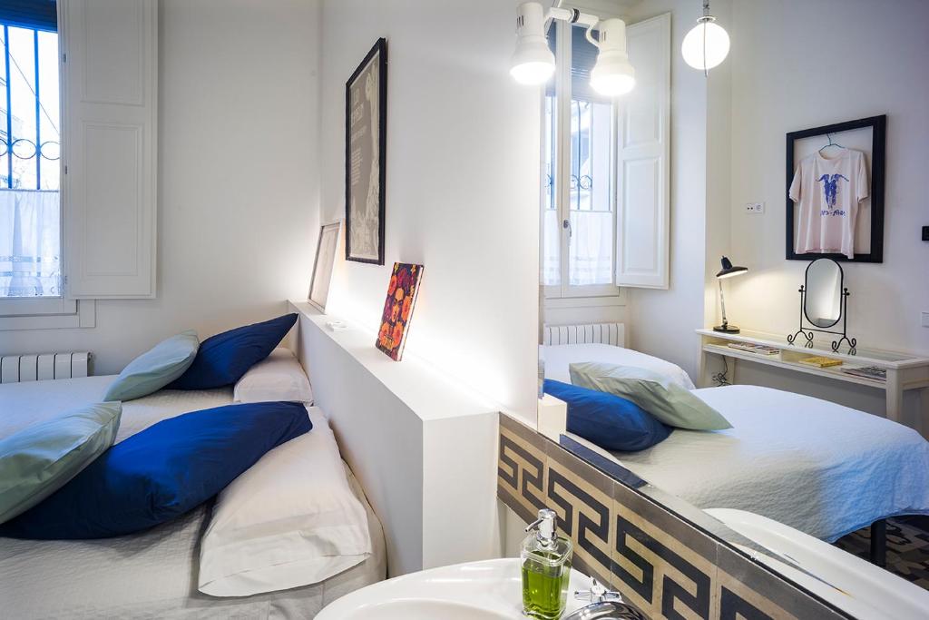 a room with two beds with blue pillows at Cal Peó ByBCardedeu in Cardedeu