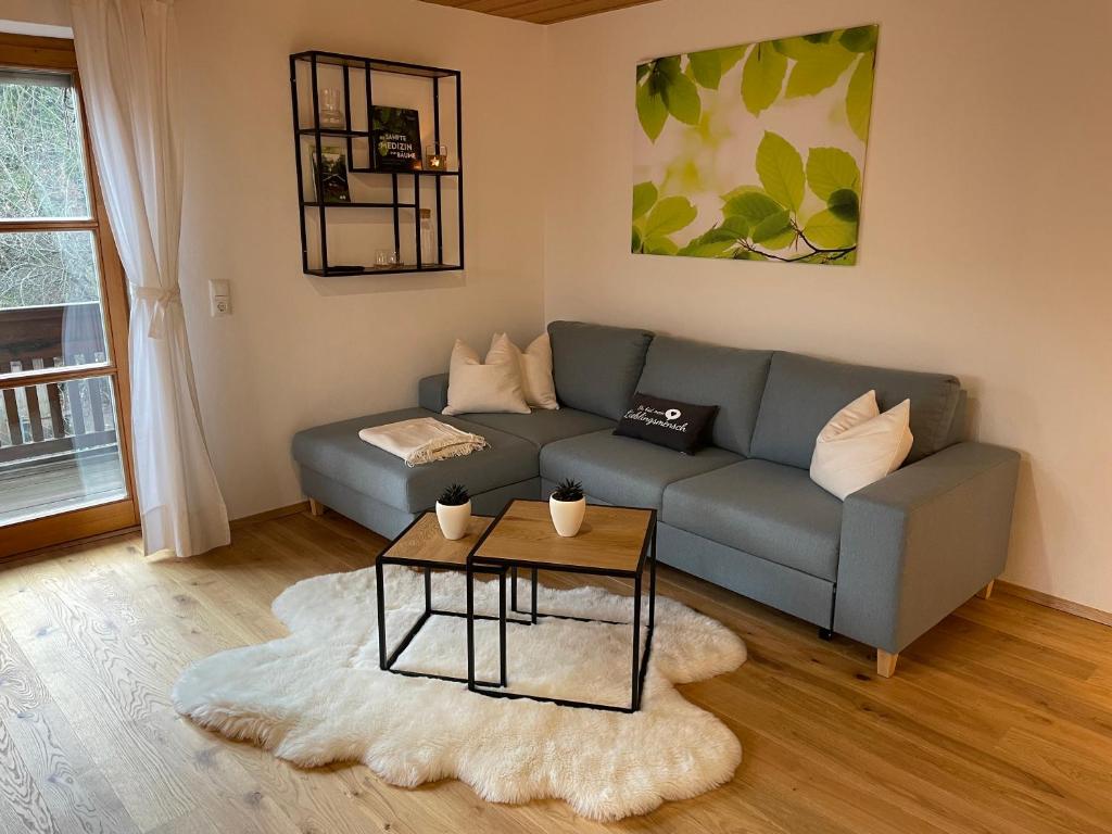 a living room with a couch and a table at Ferienwohnung Hofleben Reiner in Neukirchen vorm Wald