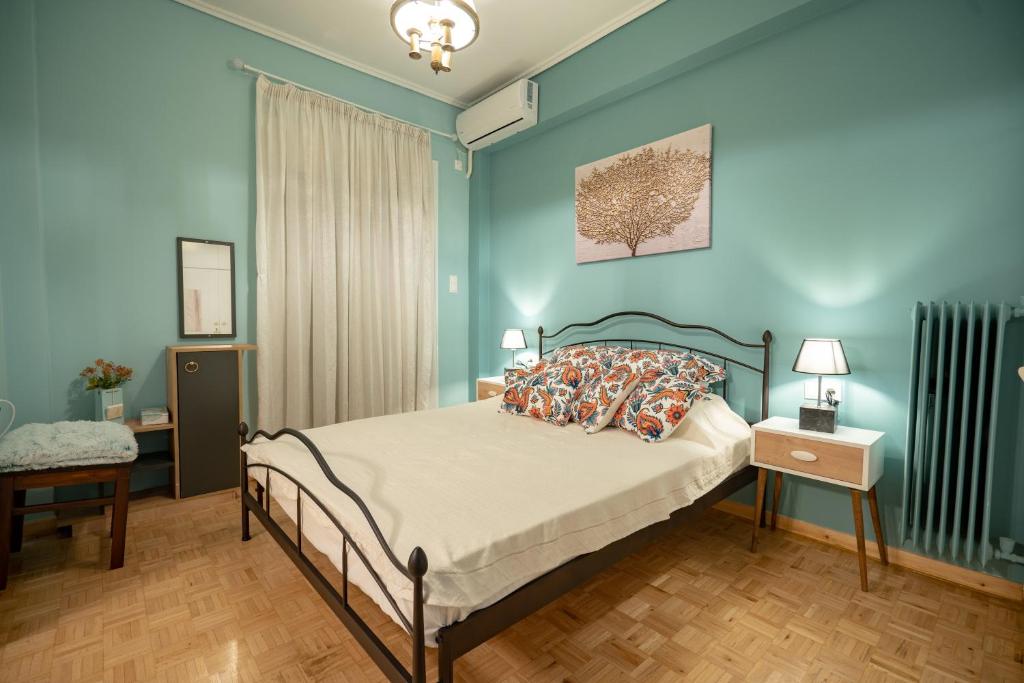 a bedroom with a bed with blue walls at Pasalimani 1 bedroom 4 persons apartment in Piraeus
