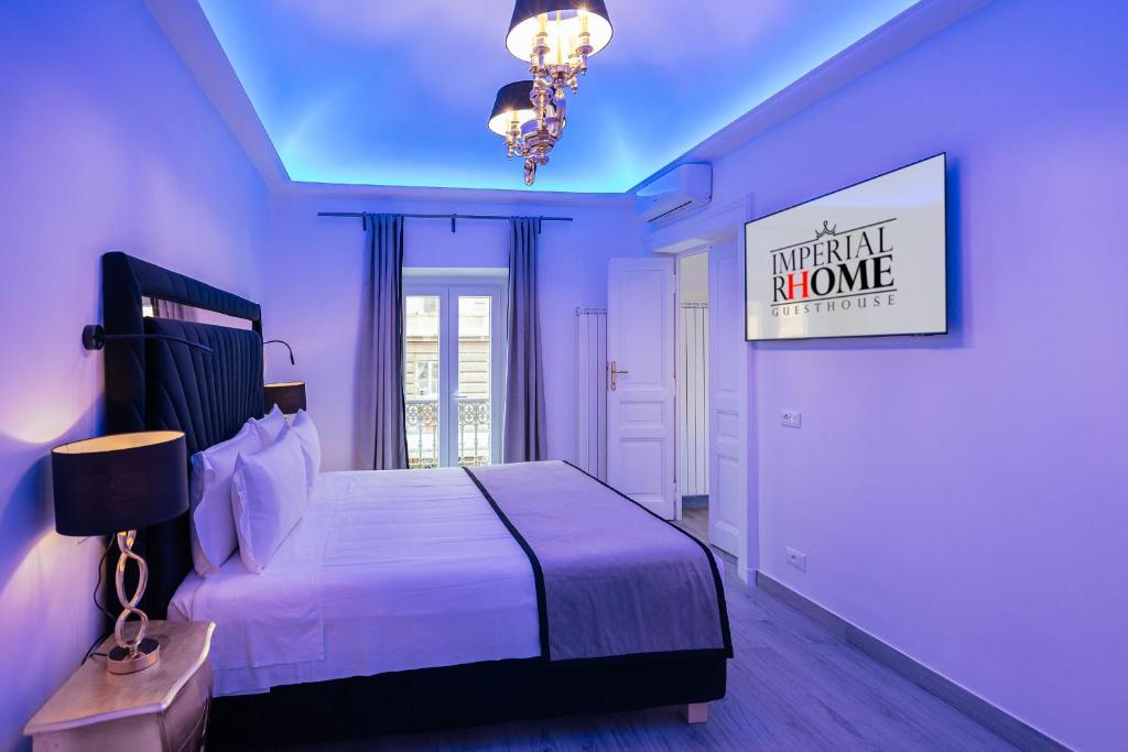 a bedroom with a large bed and a chandelier at Imperial Rhome Guest House in Rome