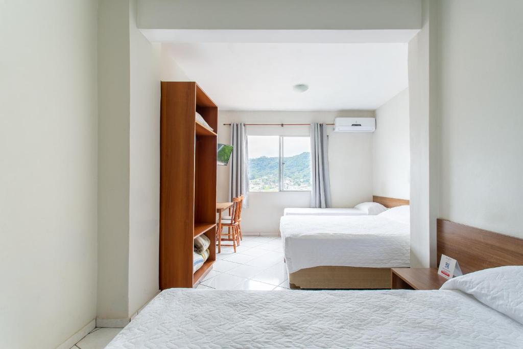 Ένα ή περισσότερα κρεβάτια σε δωμάτιο στο Hotel Dom Rafael Express