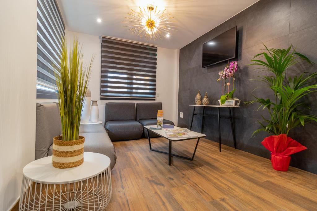 a living room with a couch and a table at Hotel Reina Aixa in Cogollos de Guadix