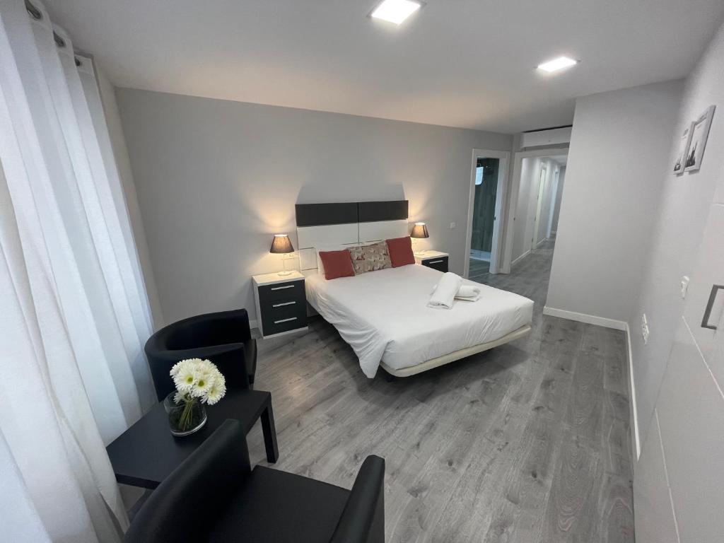 a hotel room with a bed and a chair at DAU Centro Free Parking in Salamanca