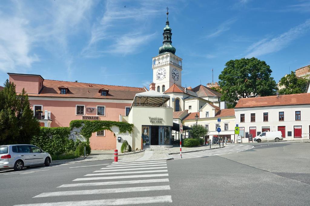 um edifício com uma torre de relógio em cima em Vivaldi Apartments em Mikulov