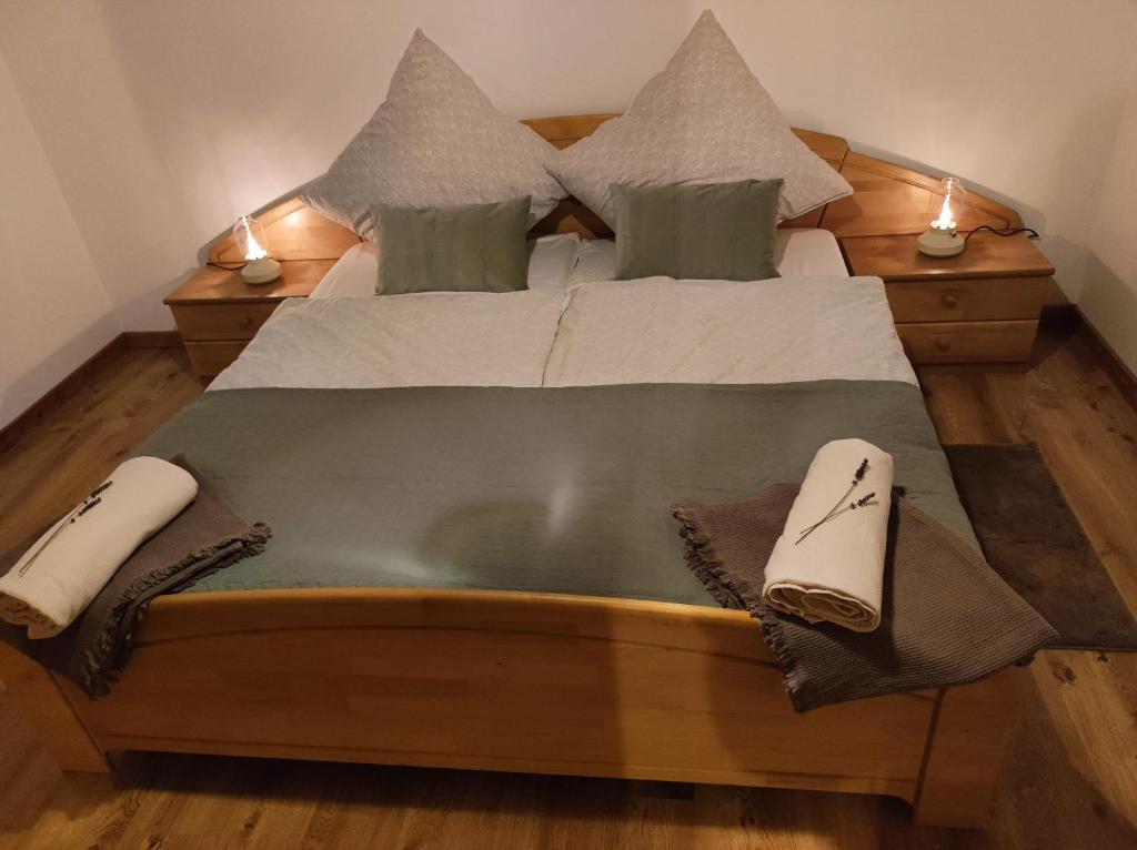 a large wooden bed with two pillows on it at Ferienhaus Hexenhäuschen in Walhausen