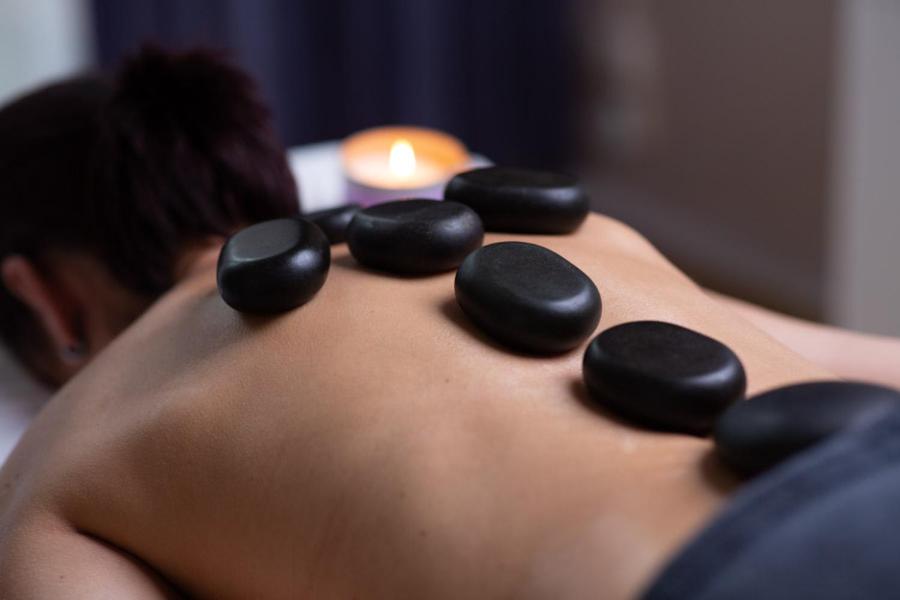 a man with black rocks on his back at OREA Spa Hotel Bohemia Mariánské Lázně in Mariánské Lázně