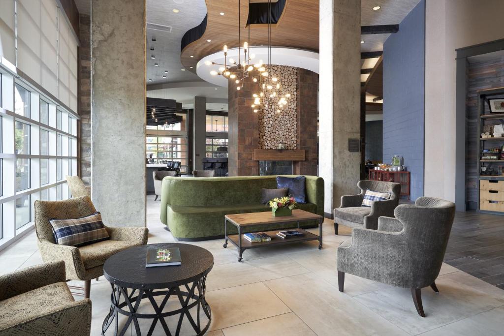 a lobby with chairs and a couch and a table at Archer Hotel Seattle/Redmond in Redmond