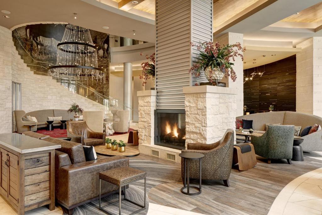 a lobby of a hotel with a fireplace at Archer Hotel Austin in Austin
