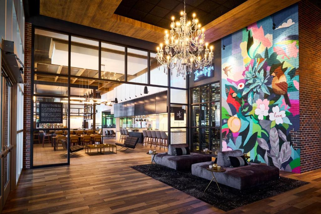 a lobby with a colorful mural on the side of a building at Archer Hotel Tysons in Tysons Corner