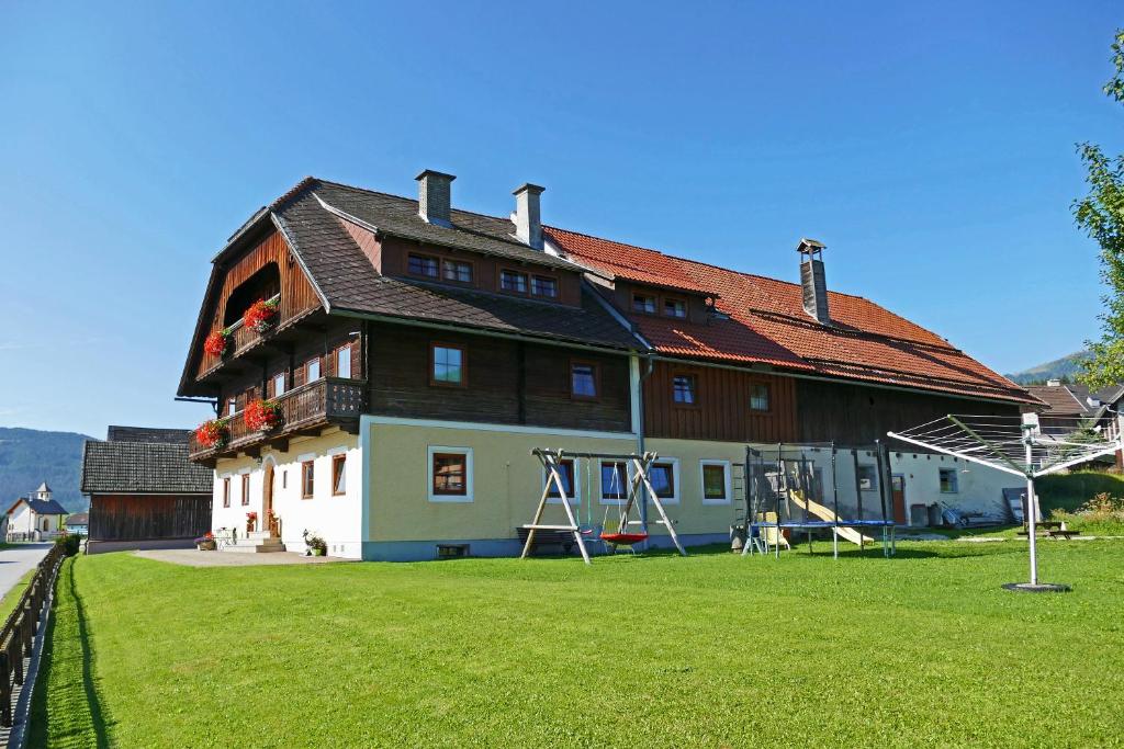 a large house with a playground in front of it at Hiaslahof in Mariapfarr