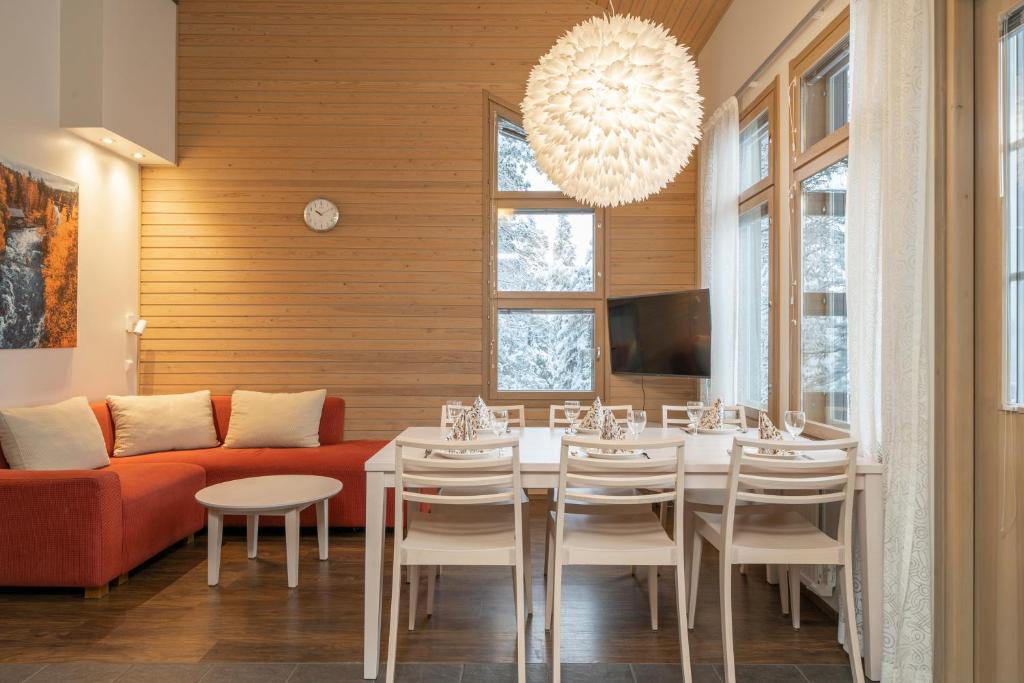 Ski-Inn MastonAitio في روكا: غرفة طعام مع طاولة وأريكة