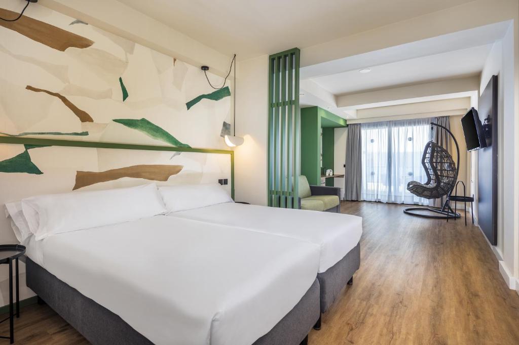 a bedroom with a large white bed in a room at Occidental Roca Negra - Adults Only in Agaete