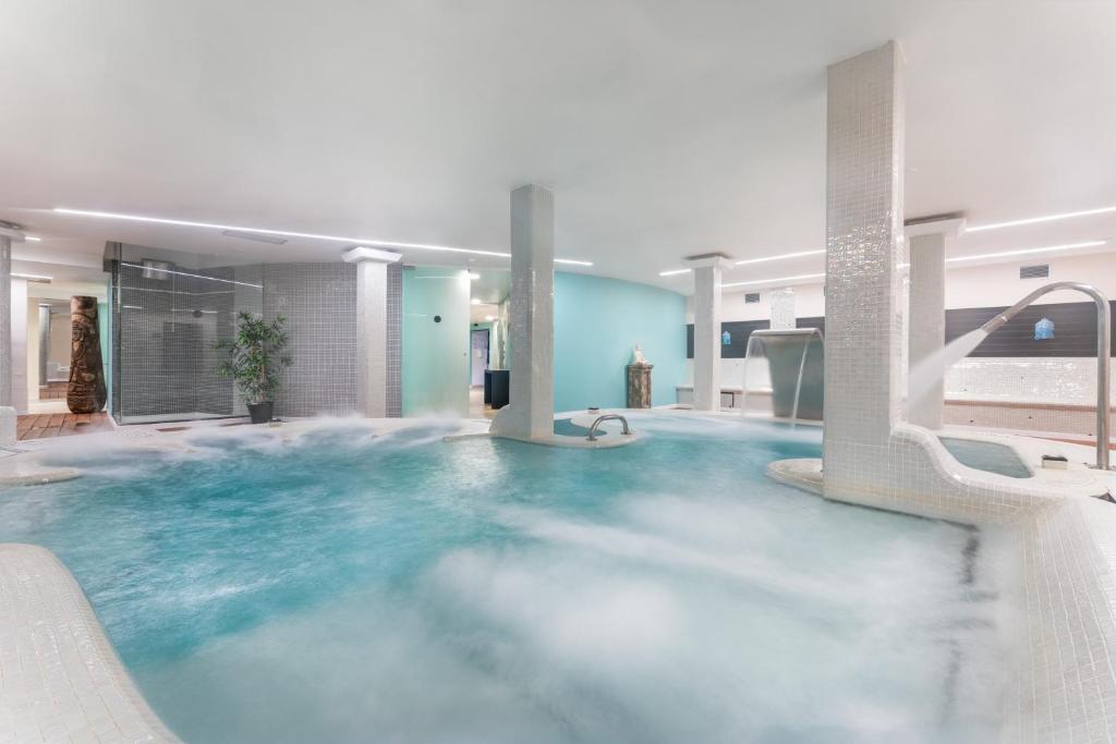 a large pool of blue water in a building at Occidental Roca Negra - Adults Only in Agaete