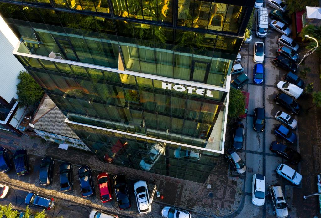 an overhead view of a hotel building with parked cars at Hotel Green Glass in Batumi