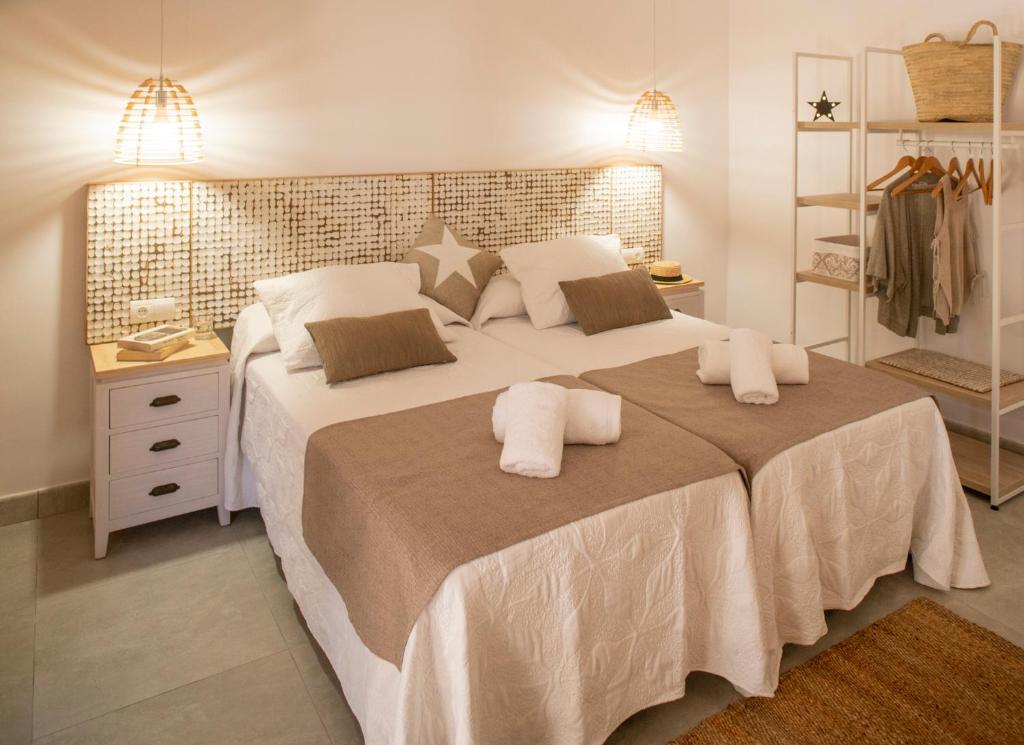 a bedroom with a large white bed with two pillows at Stella Maris - Formentera Break in Playa Migjorn