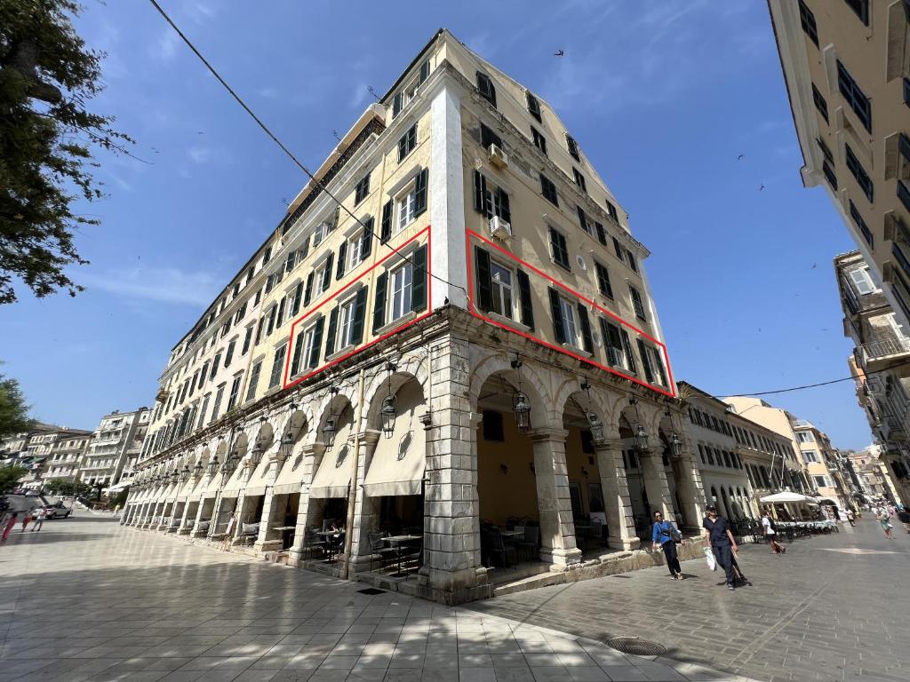 a tall building with people standing in front of it at LISTON'S Central Suites in Corfu Town