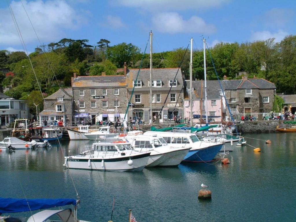a group of boats are docked in a harbor at 10 Mill Road in Padstow