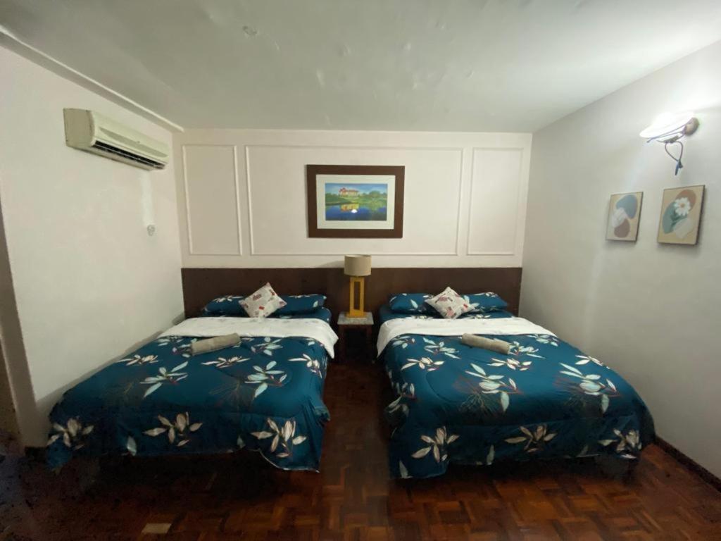 a room with two beds in a room at D'Sofiya Homestay A Famosa Melaka in Melaka