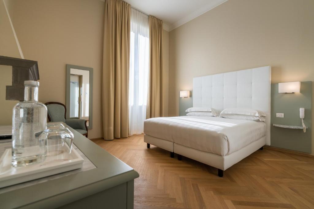 Postel nebo postele na pokoji v ubytování Hotel Ariele