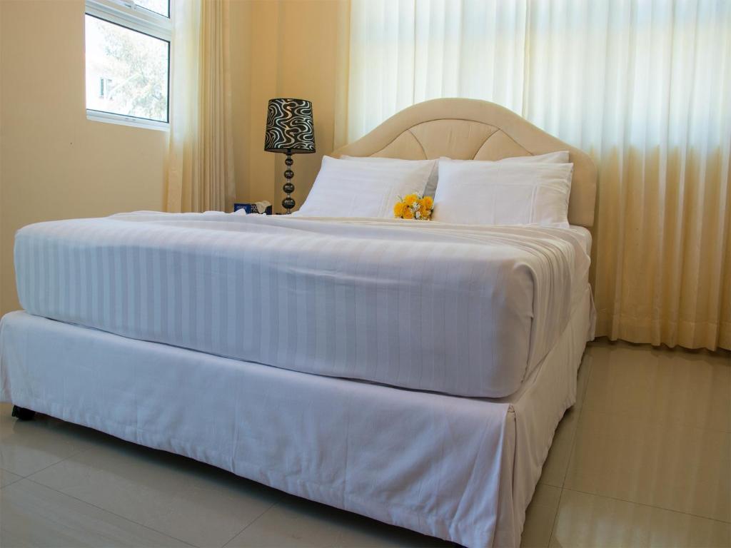 Postel nebo postele na pokoji v ubytování Beach Palace