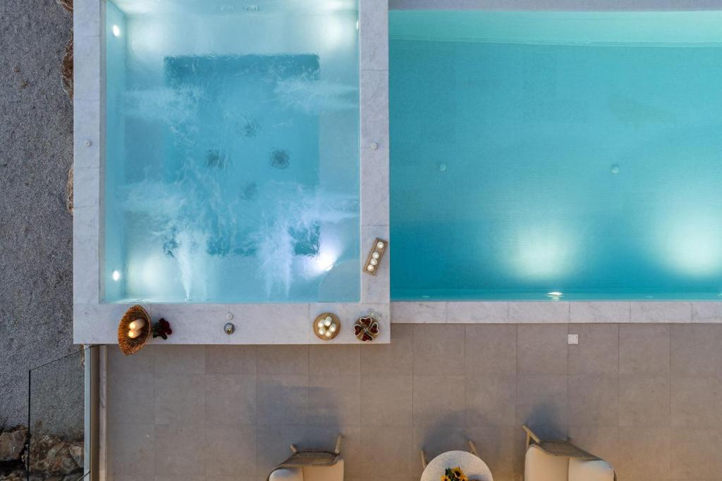 a bathroom with a large window above a toilet at Villa Empire with Magical sea view in Chania