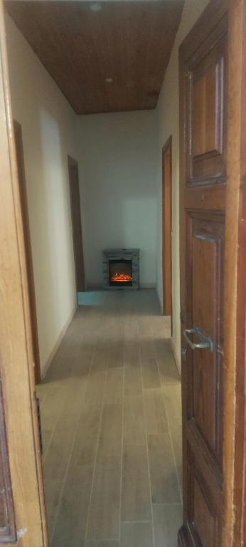 an empty hallway with a fireplace in a room at WHOLE HOLIDAY HOME APARTMENT LOVELY CIVITAVECCHIA da PAMINO & PRISCILLA in Civitavecchia