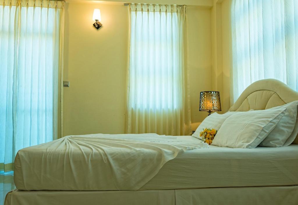 Postel nebo postele na pokoji v ubytování Beach Palace