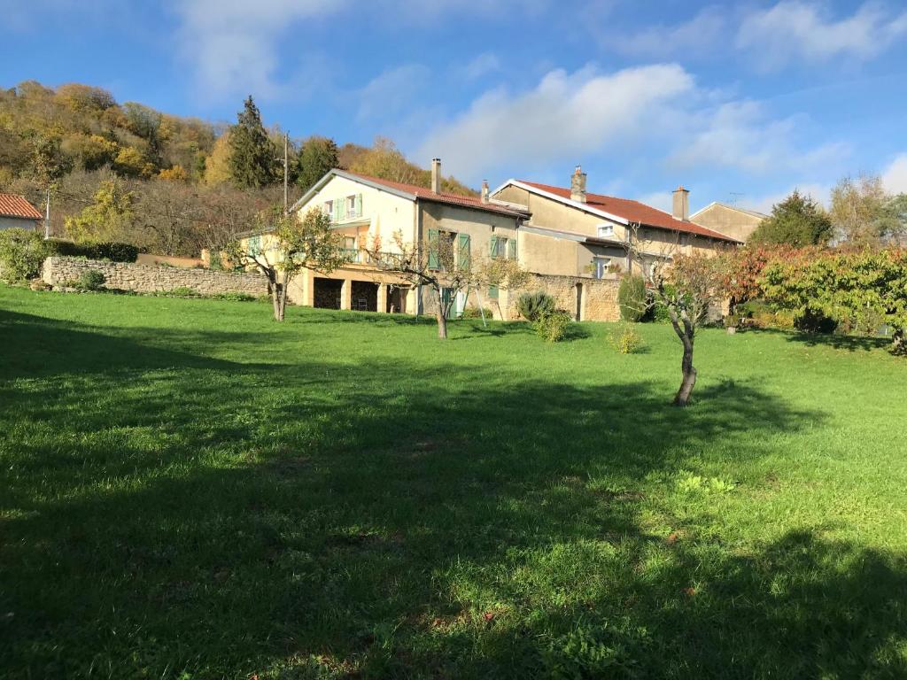 a large yard with a house in the background at GITE DE LA FONTAINE 