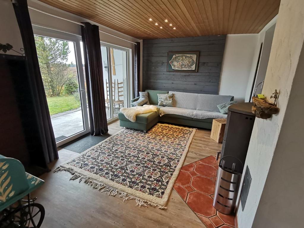 a living room with a couch and a rug at adBs Ferienhaus in Winterberg
