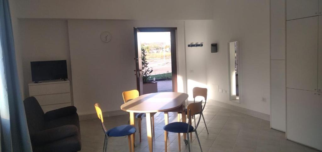 a dining room with a table and chairs and a television at Venere Home in Ponte Galeria