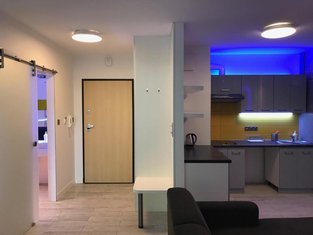 a room with a kitchen with a blue light at La Petite APARTMENTS in Gdańsk