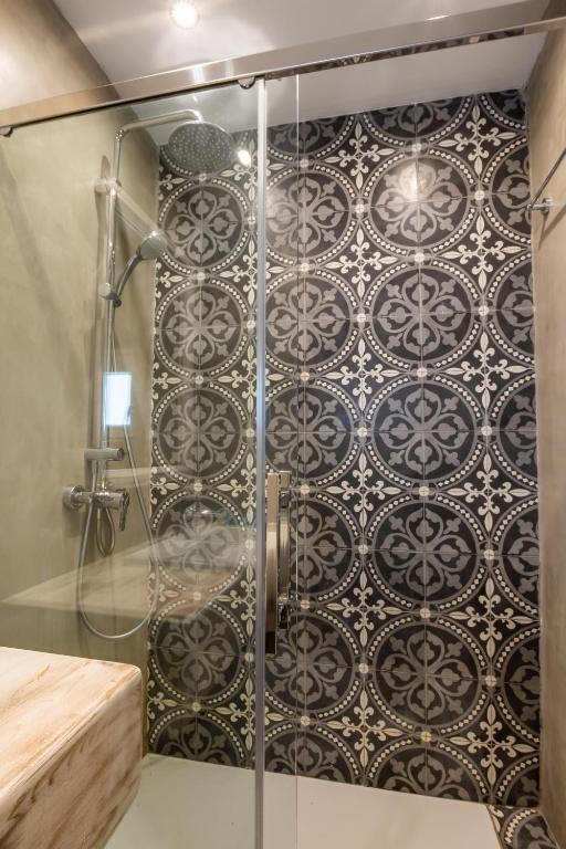 a shower with a glass door in a bathroom at Poseidon Blue Gastronomy Hotel in Afiartis