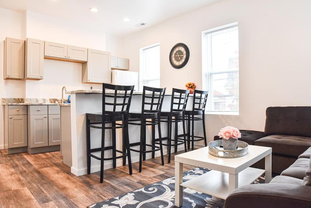 a kitchen and living room with a table and chairs at Beautiful Pittsburgh home-walkable area w parking in Pittsburgh