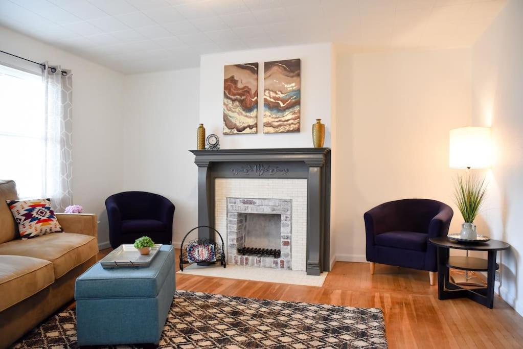a living room with a couch and a fireplace at Relax & Feel At Home During Your Pittsburgh Stay in Pittsburgh