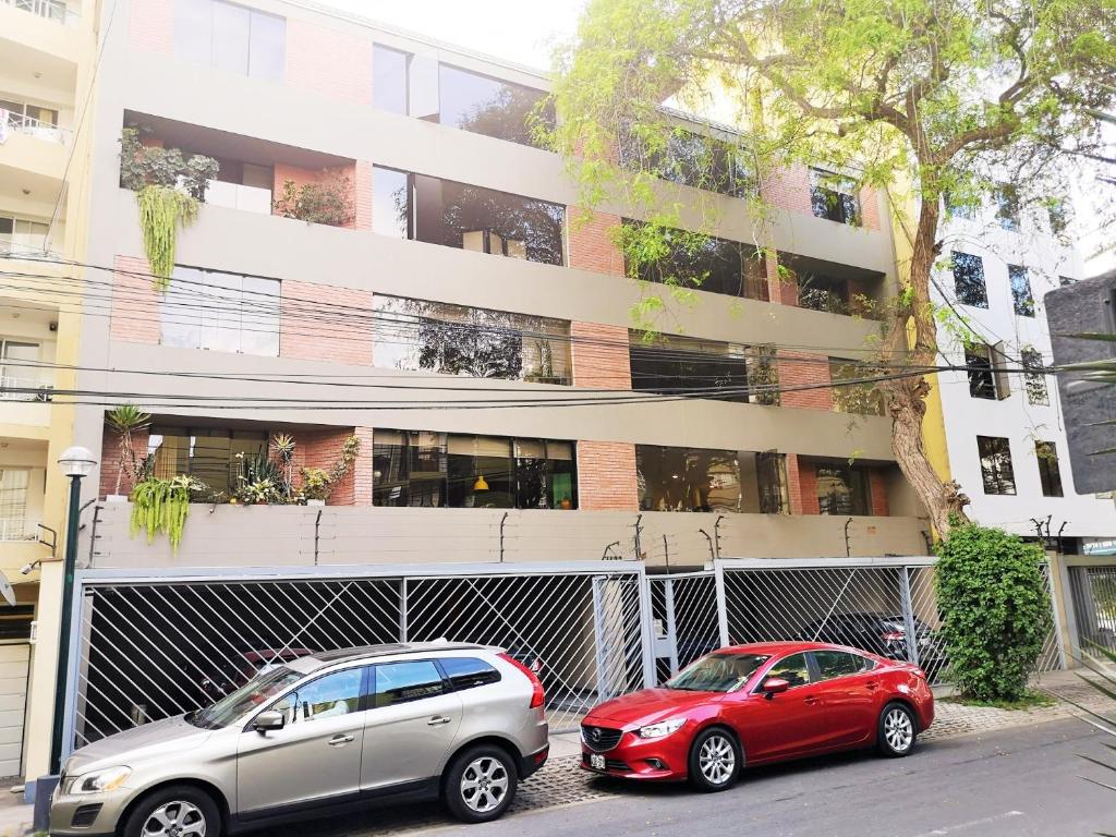 two cars parked in front of a building at Espacio Luxury Apartments- Edificio Alcanfores in Lima