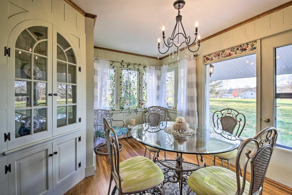 a dining room with a glass table and chairs at Peaceful Maine Home with Patio Ocean Inlet Getaway! in Bath