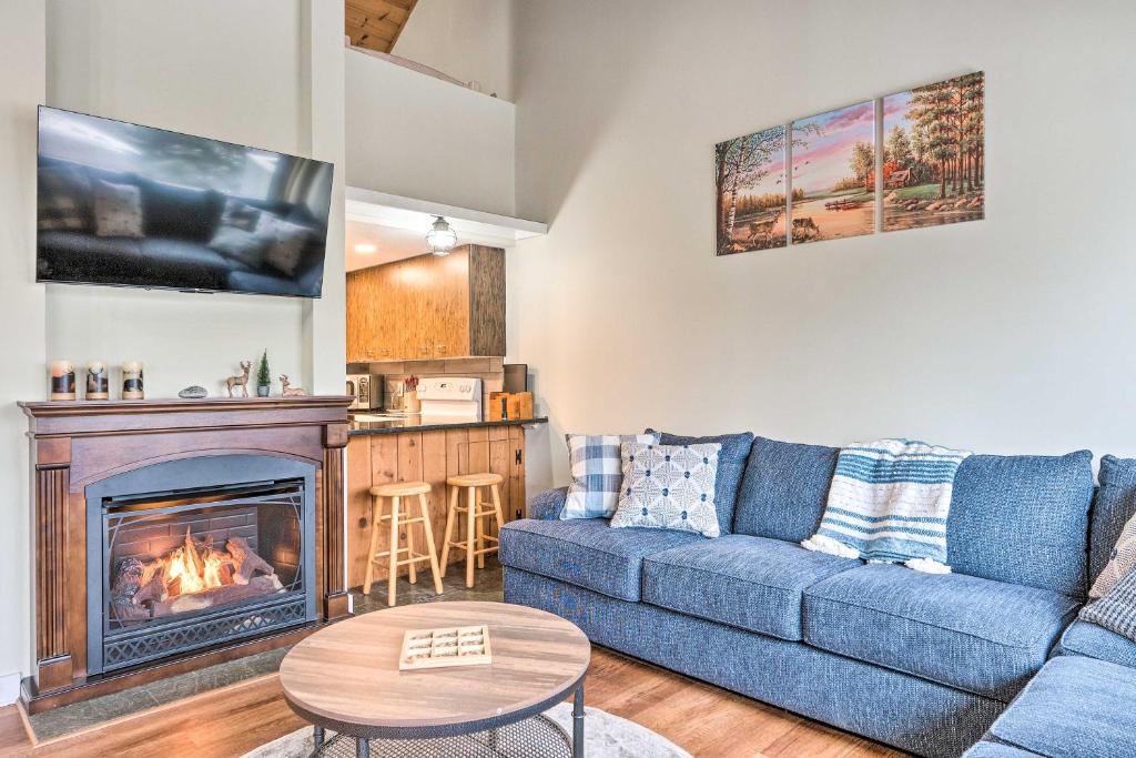 a living room with a couch and a fireplace at Stunning Lincoln Escape with Deck and Mtn Views! in Lincoln