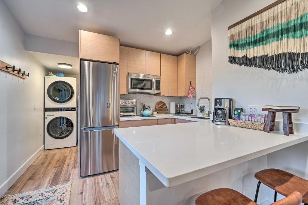 a kitchen with a counter and a refrigerator at Cozy Flagstaff Studio with Patio - Near Dtwn! in Flagstaff