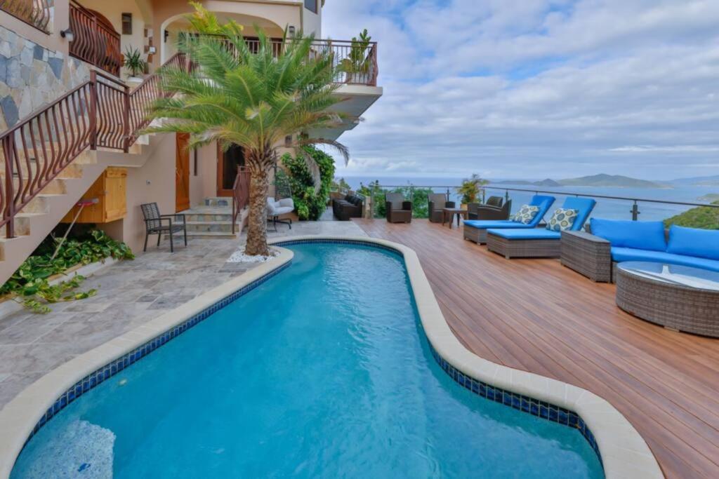 a swimming pool on the deck of a house at Cheerful 3 -bedroom villa with Pool in Tortola Island