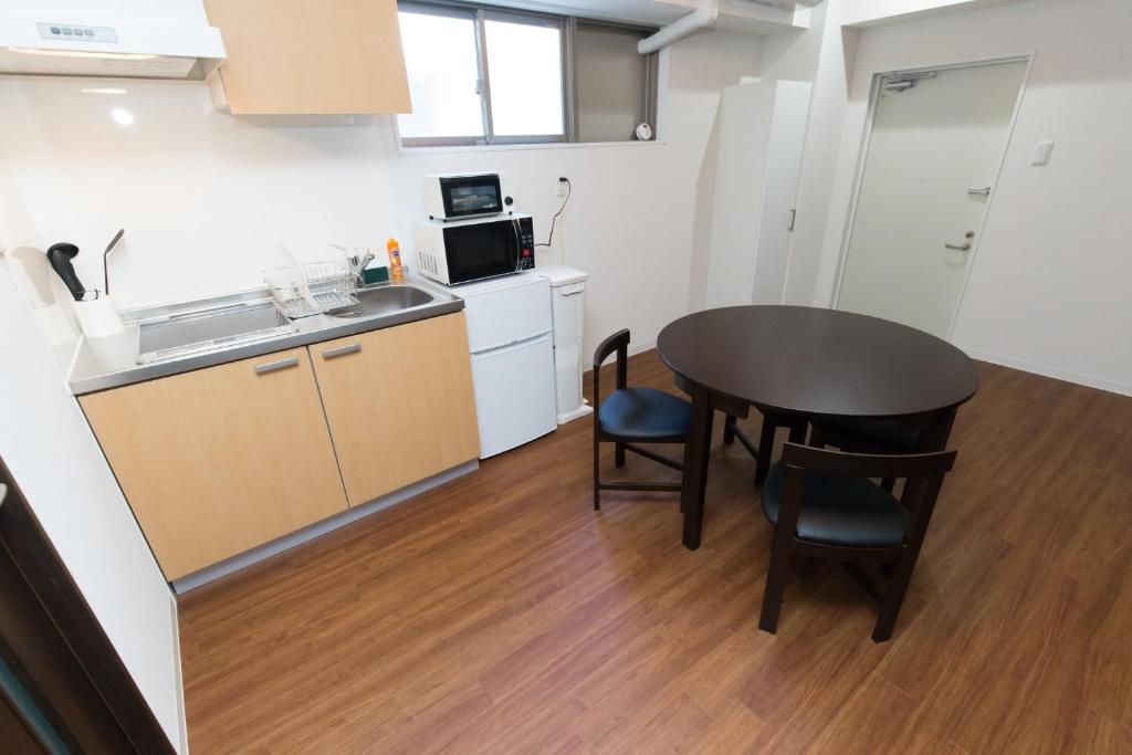 a small kitchen with a table and a sink at Amber Iidabashi - Vacation STAY 87072v in Tokyo