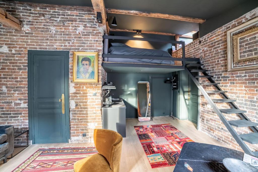 Cette chambre est dotée de lits superposés et d'un mur en briques. dans l'établissement Place Vendôme Luxe 60 SQM Bail mobilité, à Paris