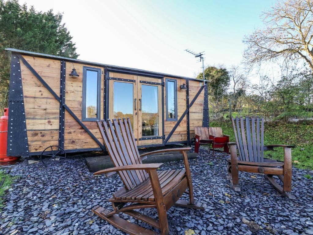 a tiny house with two chairs and a table at The Suffolk in St Asaph