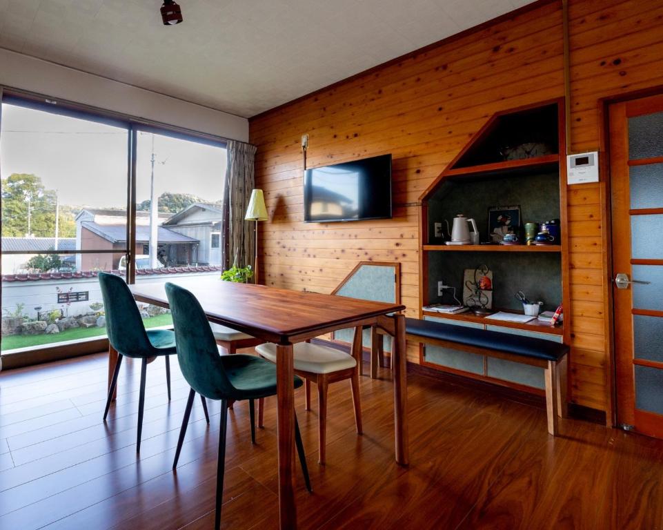 a wooden dining room with a table and chairs at Yuan - Vacation STAY 01317v in Matsue