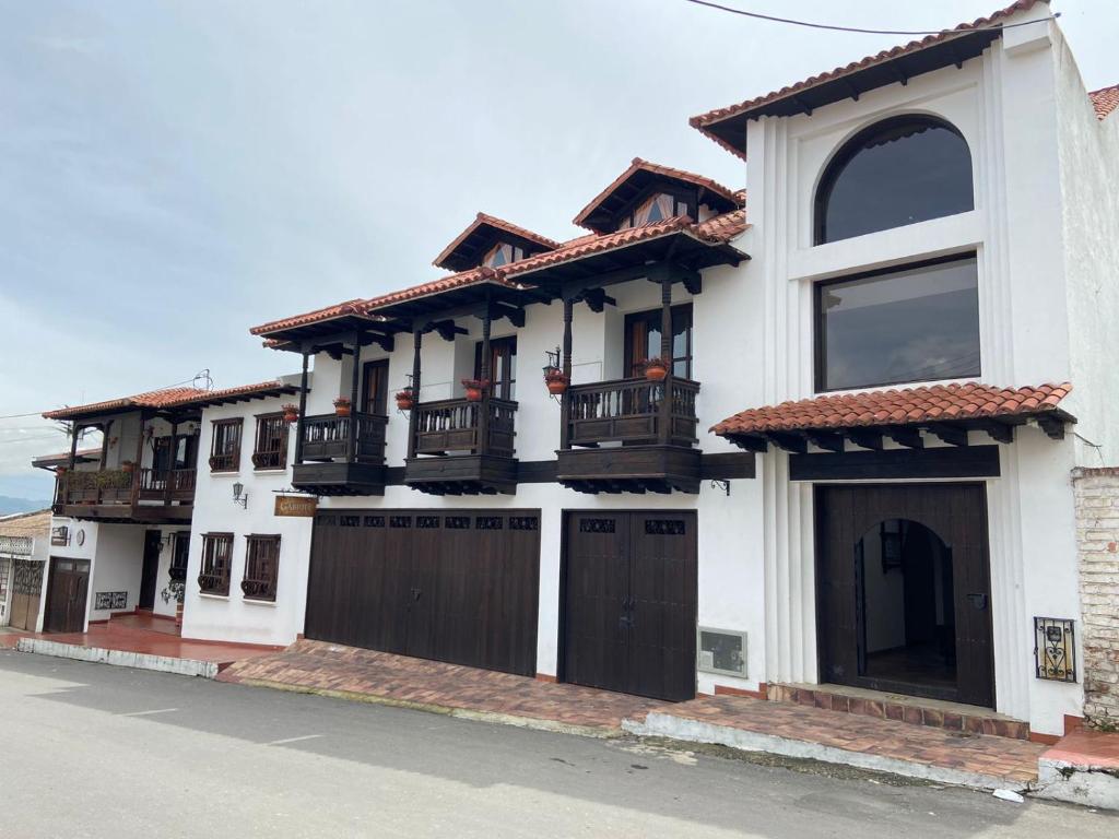蒂瓦索薩的住宿－San Gabriel Hospedería，白色的房子,设有棕色的门和窗户