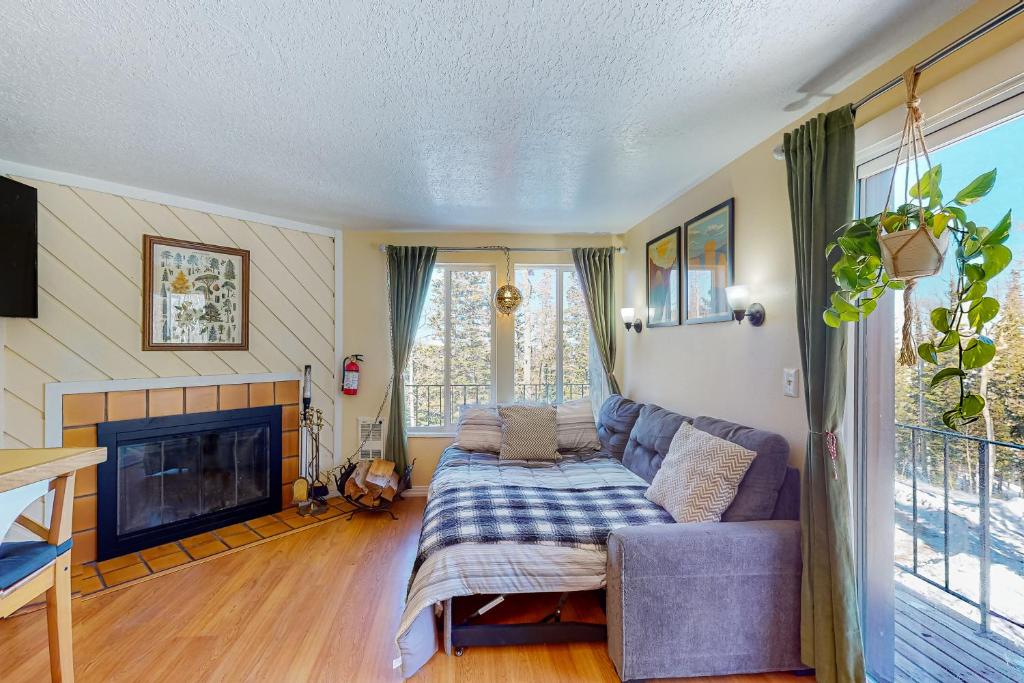 a living room with a couch and a fireplace at Timberbrook B210 in Brian Head